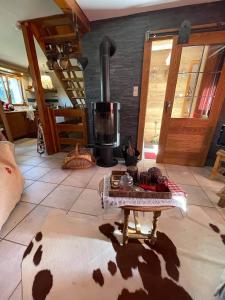 a living room with a coffee table and a stove at Chalet Le Cerf in Wildersbach