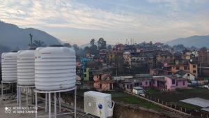 a group of white tanks sitting on top of a city at CITY CROWN GUEST HOUSE in Sundarnagar