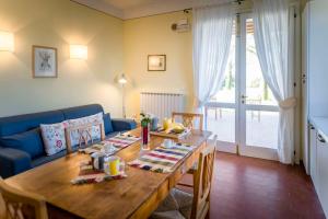 ein Wohnzimmer mit einem Holztisch und einem blauen Sofa in der Unterkunft Maranghetto appartamenti in Caorle + 61 Fotos