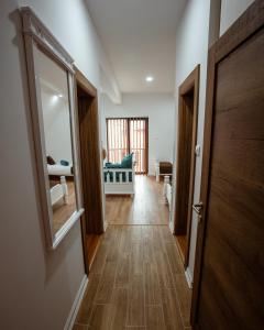 a hallway with a door to a room at Vila ZLATARSKA PAHULJA --- apartman " BELE NOĆI " in Nova Varoš