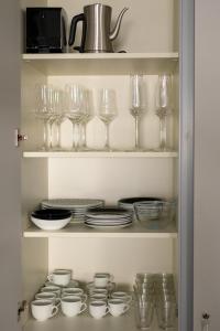 a cupboard filled with glasses and plates and dishes at Apartamento frente telecabina Vallnord - Bike park 641 in La Massana
