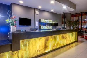 a bar in a lobby with a yellow counter at Vestina Wellness & SPA Hotel in Międzyzdroje