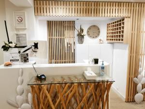 a room with a counter with a clock on the wall at Cit'Hotel Imperial in Sète