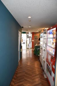 a hallway of a convenience store with vending machines at Hotel Mikado in Osaka