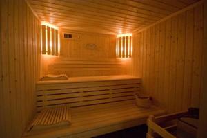 a wooden sauna with a bench and lights in it at Дом Писателей Цахкадзора in Tsaghkadzor