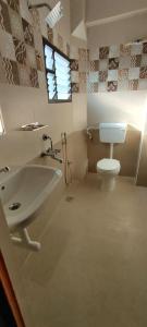 La salle de bains est pourvue d'un lavabo et de toilettes. dans l'établissement Hotel Temple View, à Madurai