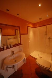 a bathroom with a sink and a toilet and a tub at Ferien-Wein-Gut Keifer in Bernkastel-Kues +27 photos