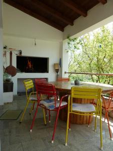 a room with a table and chairs and a fireplace at Apartment Mrkić in Biograd na Moru