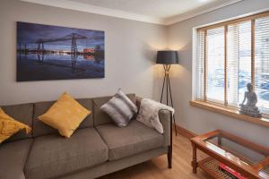 a living room with a couch and a window at Host & Stay - Amber Shores in Saltburn-by-the-Sea