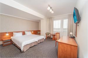 Postel nebo postele na pokoji v ubytování Vestina Wellness & SPA Hotel