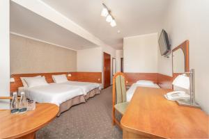 Postel nebo postele na pokoji v ubytování Vestina Wellness & SPA Hotel