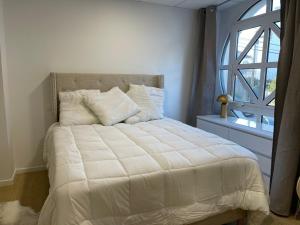 Schlafzimmer mit einem großen Bett und einem Fenster in der Unterkunft L'Eden in Vannes