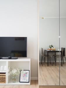 a living room with a table and chairs at Apartamenty KDN na Rysiej in Katowice