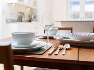 
a table topped with plates and bowls filled with food at 10 Tivoli Mews - By Luxury Apartments in Cheltenham

