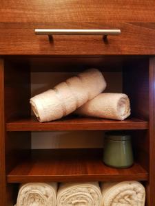 two rolled up paper towels sitting on a shelf at Cosy one bedroom apartment, close to Iulius Mall in Cluj-Napoca