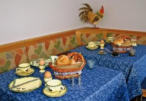 a table with a blue table cloth with a chicken on top at Gästehaus Wald und See in Titisee-Neustadt
