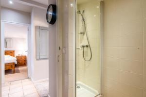 a bathroom with a shower with a glass door at SCHUSS D4 in Morzine