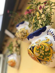 a group of vases with flowers in them at Casa del Ginnasio - Taormina city center in Taormina