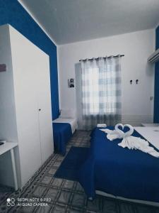 Postel nebo postele na pokoji v ubytování Stanze Di Leo