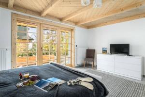 a bedroom with a bed with a tray of food on it at Willa Pitoniówka z sauną, Netflix oraz Xbox one in Kościelisko