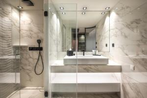 a bathroom with a sink and a mirror at Rivage Hôtel & Spa Annecy in Annecy