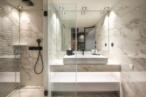 
a bathroom with a tub and a mirror at Rivage Hôtel & Spa Annecy in Annecy
