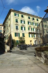 a large yellow building with motorcycles parked in front of it at a due passi dal centro in Genoa