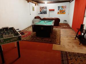 a living room with a pool table in the middle at B&B Esprit d'un Moment in Nolay
