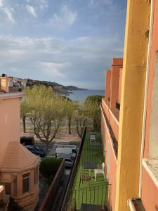 a view of the ocean from a balcony of a building at Hotel Les Pecheurs in Banyuls-sur-Mer