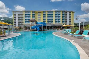 a large swimming pool with chairs and a hotel at Margaritaville Resort Gatlinburg in Gatlinburg