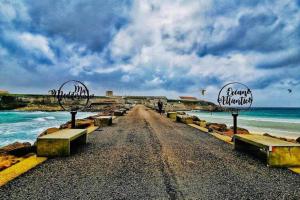 a dirt road with benches on the beach at Apartamento Lances playa tarifa in Tarifa +39 photos