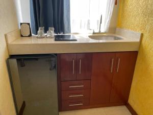 a kitchen with a sink and a counter top at Departamentos K&B in Playa del Carmen