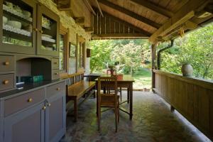 a kitchen with a table and a dining room at Cottage on Hill in Donja Stubica