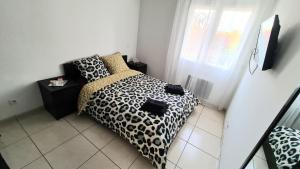 a bedroom with a leopard print bed and a window at VILLA PISCINE DE LA GARRIGUE in Florensac +24 photos