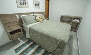 a bedroom with a bed with a pillow on it at Pousada Vivenda Verde in Pirenópolis