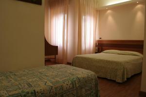 Postel nebo postele na pokoji v ubytování Hotel Sirena