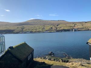 a view of a large body of water with a building at Thor´s Guest house in Ryggur