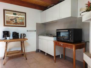 una cucina con forno a microonde e tavolo con TV di un PO sul Delta ad Ariano nel Polesine