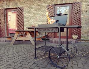 a table with a grill with a laptop on it at Zaļais namiņš in Ventspils +22 photos