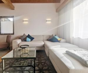a living room with a couch and a table at The Seefeld Retreat - Central Family Friendly Apartments - Mountain Views in Seefeld in Tirol