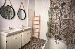 a bathroom with a sink and a shower and a mirror at Old Charming Faro Apartment in Faro +26 photos
