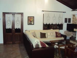 a living room with a couch and a table at Vassilis Guesthouse in Rapsáni