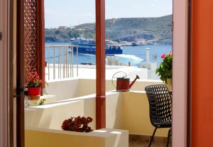 a balcony with a view of the water at Pefkakia Park in Ermoupoli