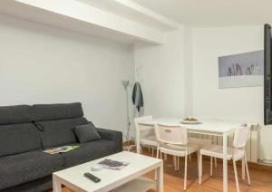 a living room with a couch and a table at Candelario apartamentos in Candelario