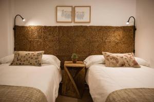 a bedroom with two beds and a wooden headboard at K-SPACE by Nuka Homes in Jávea
