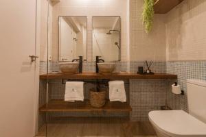 a bathroom with two sinks and a mirror and a toilet at K-SPACE by Nuka Homes in Jávea +25 photos