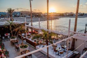 a balcony of a resort with tables and palm trees at K-SPACE by Nuka Homes in Jávea