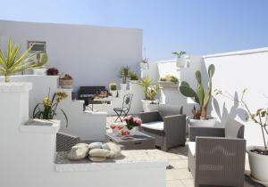 a white room filled with lots of plants at Palazzo Stapane in Santa Maria al Bagno