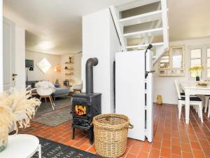 a living room with a stove and a ladder at 4 person holiday home in Skagen in Skagen