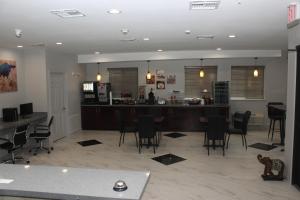 パリスにあるParis Inn & Suitesのリビングルーム(椅子付)、キッチン、バー